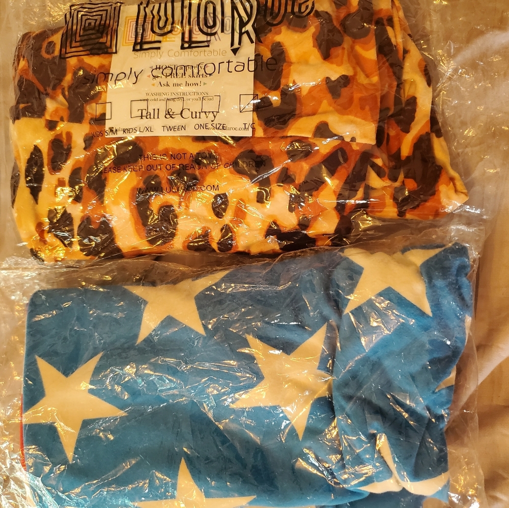 2 pairs TC Lularoe Leggings- New, never worn. Stars n Stripes and Leopard Print